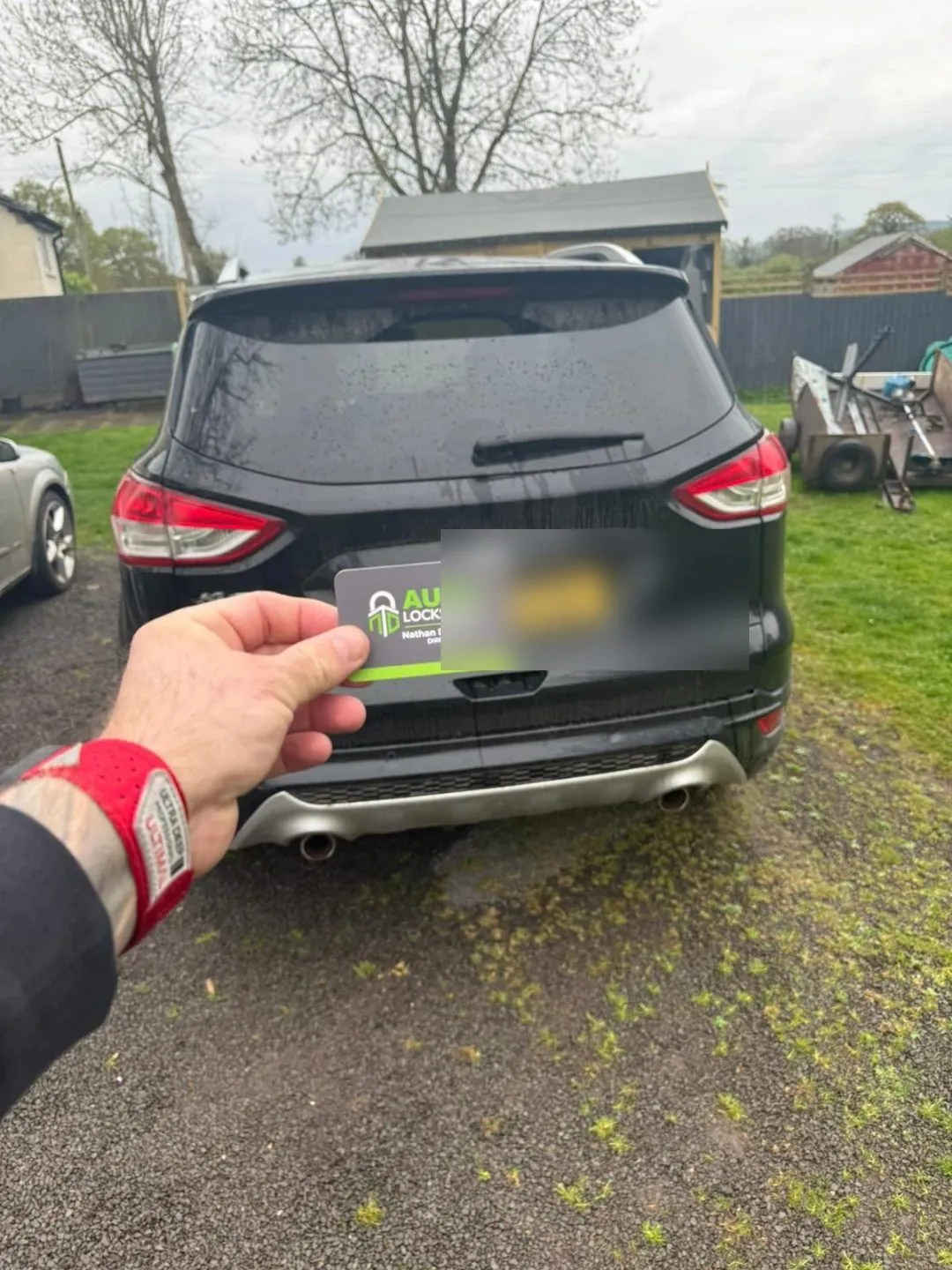 Replacement Ford car key held up beside a customer